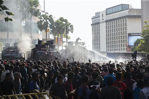 Sri Lankan Riot Police Officers Fire Tear Gas And Water Cannons At