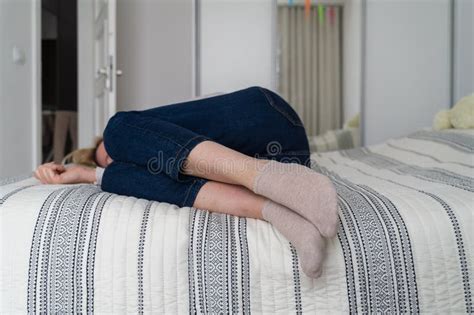 Mature Woman Curled Lying On The Bed At Home Top View Depression