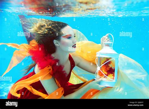 Underwater Fashion Portrait Of Beautiful Blonde Young Woman In Red