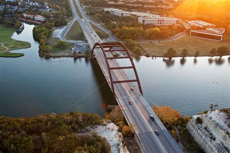 Aerial View At Sunset Of The Pennybacker 360 Bridge On Colorado River