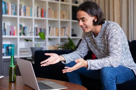 Happy Biracial Man Sitting On Sofa Using Laptop For Video Call Stock Photo Image Of Home