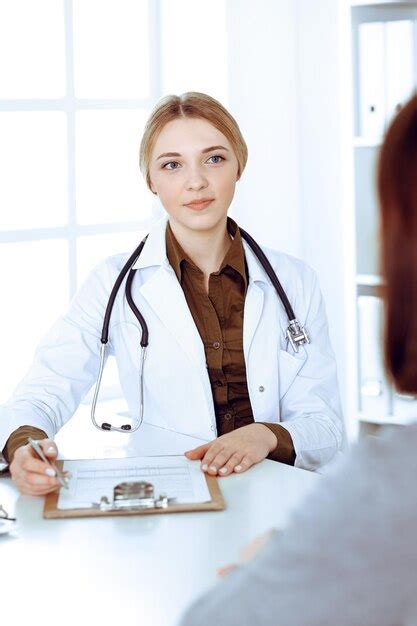 Premium Photo Young Woman Doctor And Patient At Medical Examination
