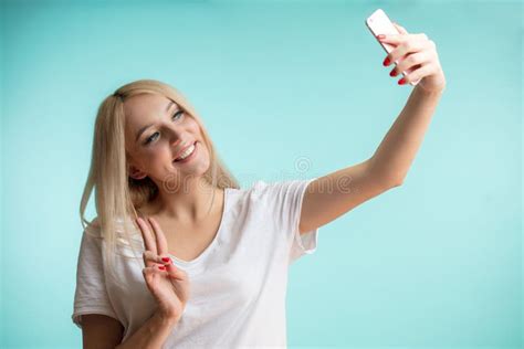 Close Up Photo Of Charming Blond Girl Taking A Selfie And Showing Two Fingers Stock Image