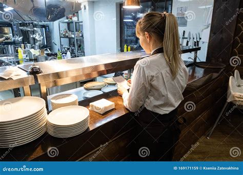 Waiters Pick Up Ready Meals In A Restaurant At The Counter For