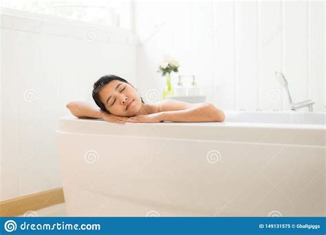 Beautiful Asian Woman Close Eye And Relax On Jacuzzi Bathtub In The