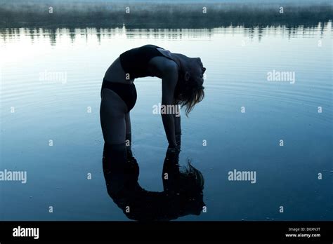 Woman Bending Backwards In Lake Stock Photo Alamy