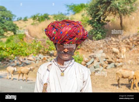 A Rajasthani Tribal Man Wearing Traditional Colorful Red Turban And