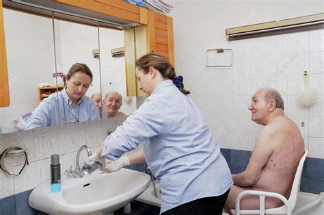 nurse washing elderly person stock image c006 3886 science photo library