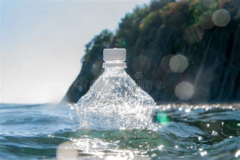 A Plastic Bottle Floats On The Water Surface By The Ocean Ecology