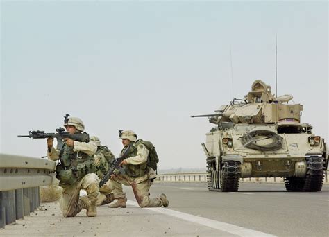 Soldiers Of The 1st Infantry Division Supported By A Bradley Fighting