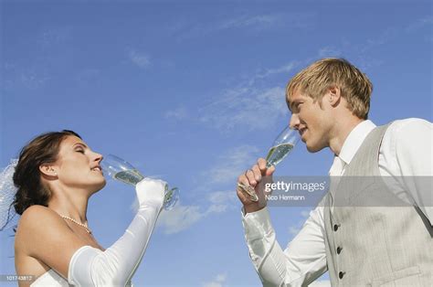 germany bavaria bridal couple drinking champagne outdoors side view portrait high res stock