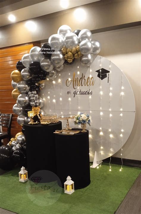 An Arch Made Out Of Balloons And Some Black And White Decorations On