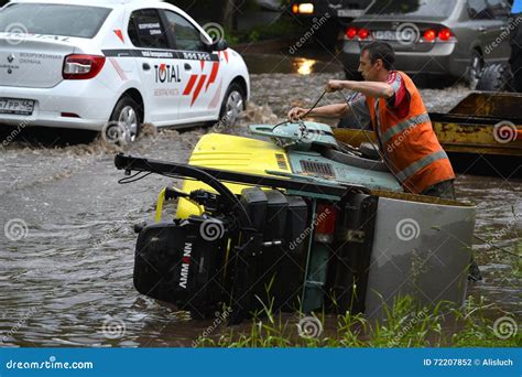car rides in heavy rain on a flooded road editorial photography image of crane event 72207852