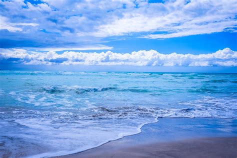 Body Of Water Under Blue And White Skies · Free Stock Photo