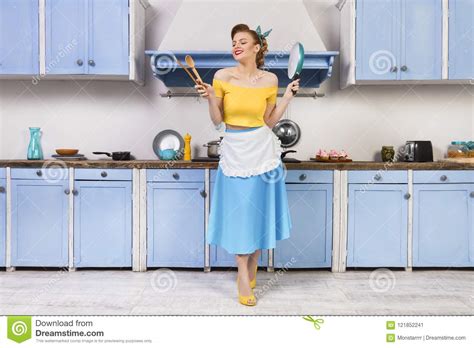 Retro Pin Up Woman Housewife Sitting In The Kitchen Stock