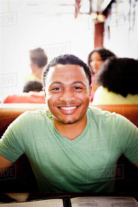 Smiling Mixed Race Man In Diner Stock Photo Dissolve