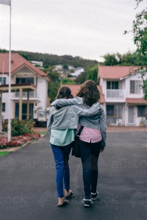 Image Of Two Friends Or Sisters Walking Together Hugging Austockphoto