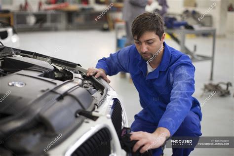 Car mechanic at work in repair garage — Engine Compartment, open ...