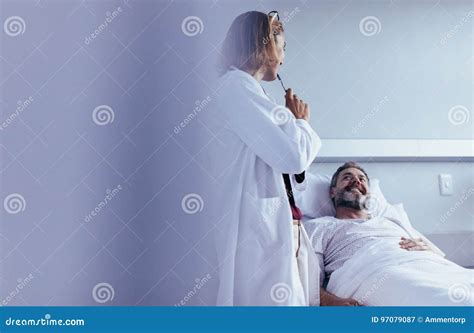 Doctor Interacting With Patient In Hospital Ward Stock Image Image Of