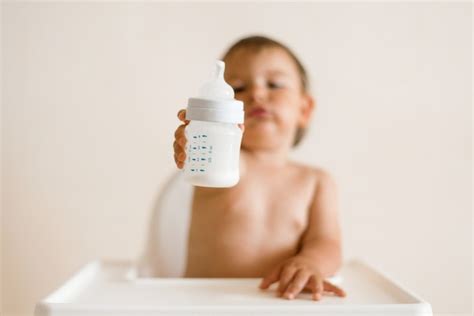 Premium Photo Adorable Baby Drinking Milk From A Bottle From Bottle
