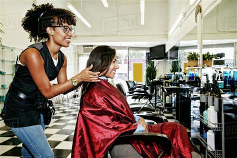 Hairstylist Styling Hair Of Customer In Salon Stock Photo Dissolve