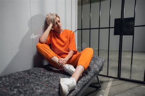 Asian Warden And A Female Prisoner In A High Security Prison Stand In