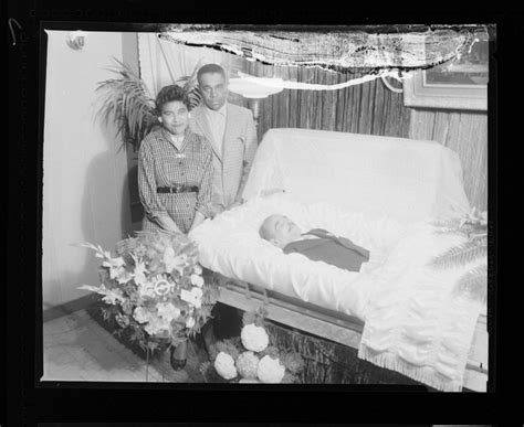 Funeral Adult In An Open Casket A Man And A Woman Standing Near