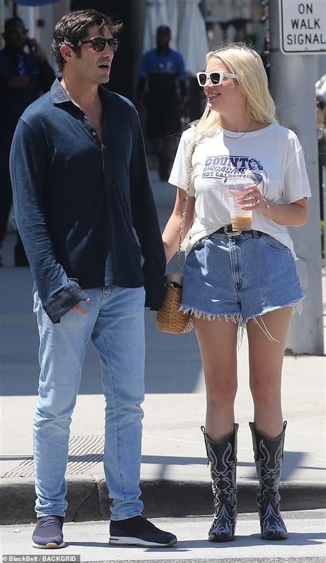 ashley benson smiles with his oil heir fiance brandon davis as they hold hands in los angeles