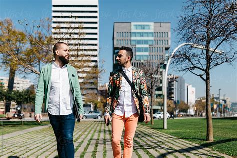 Gay Couple Walking Against Business Buildings Del Colaborador De Stocksy Guille Faingold