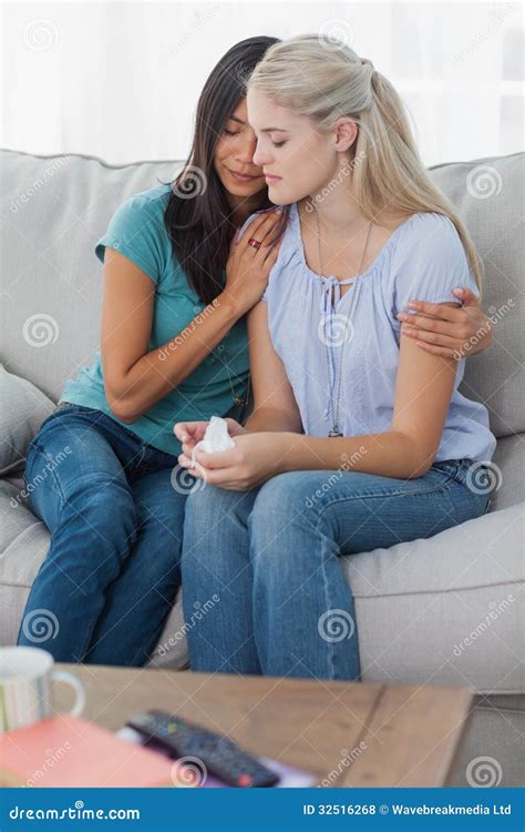 Concerned Woman Comforting And Hugging Her Sad Friend Stock Photo