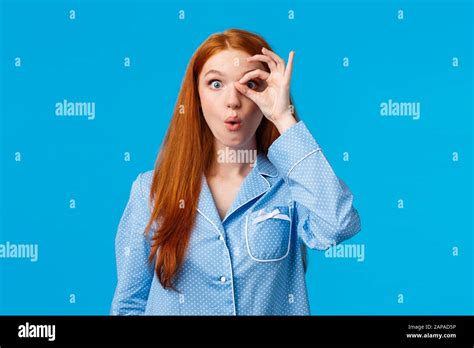 wow amazing impressed and surprised curious redhead woman staring at something intriguing