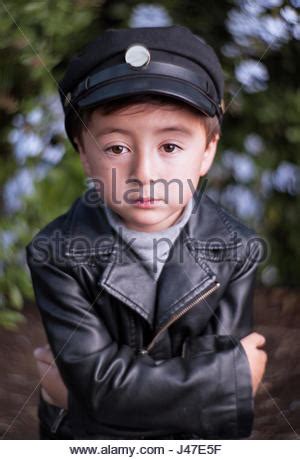 Fashion little boy wearing a leather jacket. Studio ...