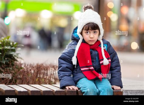 Sad Boy Sitting On A Bench Stock Photo Alamy