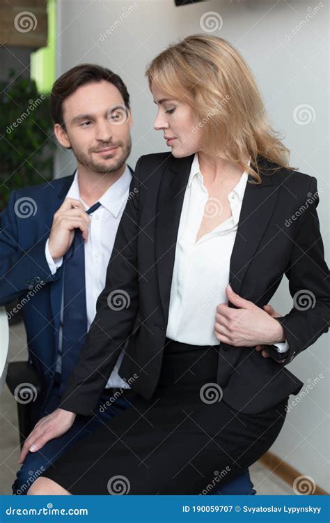 Adorable Blonde Flirts With Boss In Office Sitting On His Lap