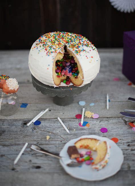 A candy cake can be a cake with candy on or in it, or it can be candy displayed to look like a cake. A Candy-Filled Piñata Cake That Hides Treats Inside