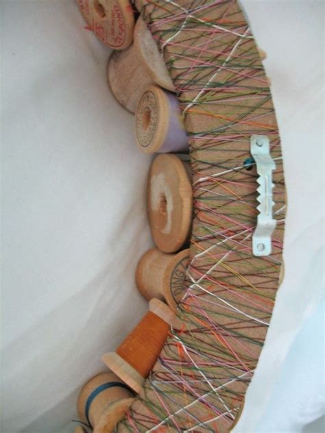 50 Different Sized Wooden Spools Glued Onto A Wooden Wreath Frame The