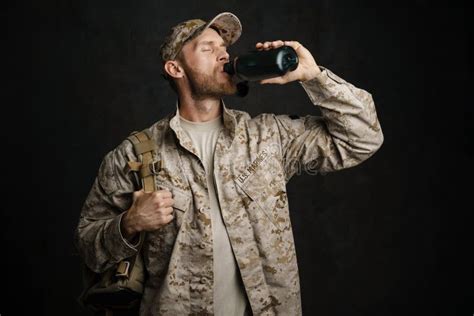 White Military Man Wearing Uniform Drinking Water From Flask Stock