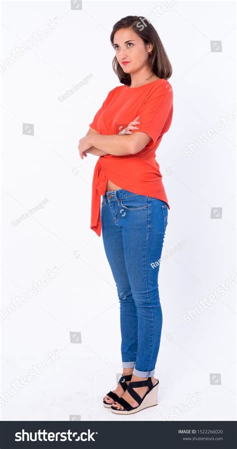 Full Body Shot Of Beautiful Woman Thinking With Arms