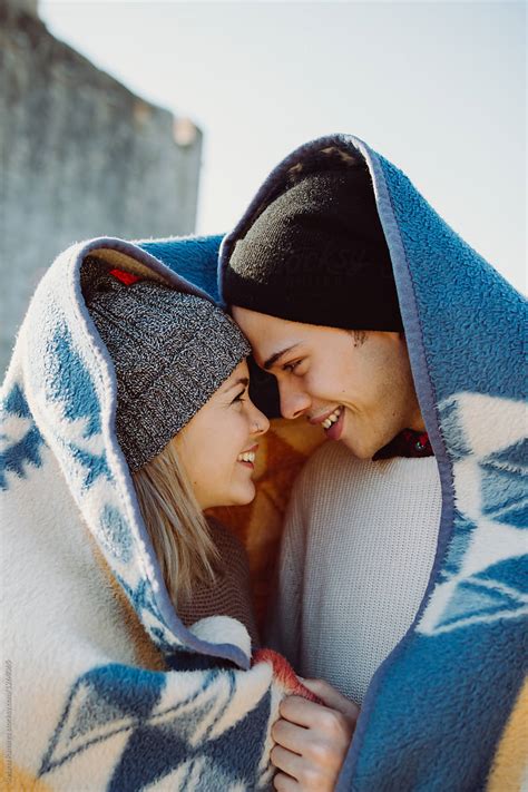 Couple Smiling Under A Blanket Del Colaborador De Stocksy Susana