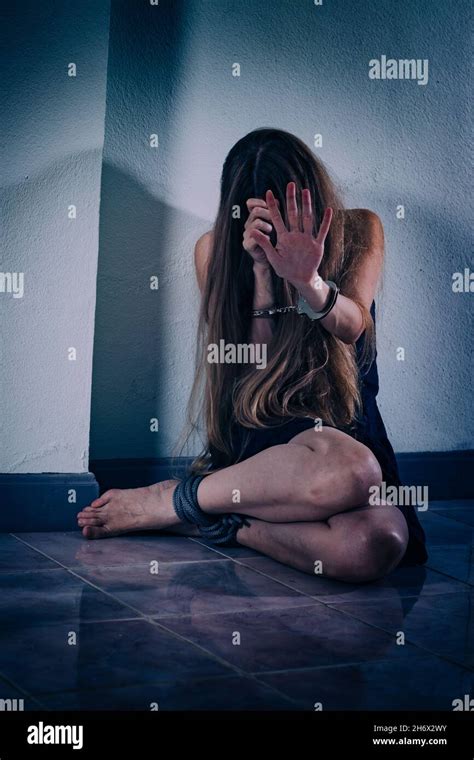 A Young Woman Suffers From Violence Sits On The Floor Covers Her Face