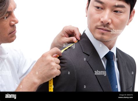 Fashion Designer Taking A Measurement Of Businessman Stock Photo Alamy