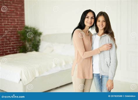 Mom And Daughter Happy Latin Mother And Daughter Smiling At Camera Looking Affectionate While