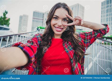 Self Portrait Of Attractive Cheerful Funky Girl Sitting In Cart Having Fun On Parking Showing V