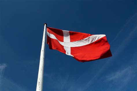 The country uses the danish it features three crowned blue lions facing left and surrounded by nine red hearts. Free Danish flag Stock Photo - FreeImages.com