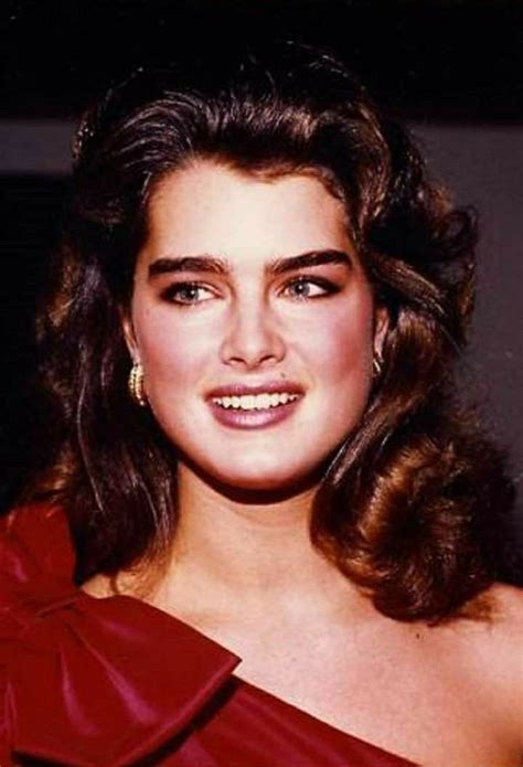 An Old Photo Of A Woman Wearing A Red Dress And Smiling At The Camera With One Eye Open