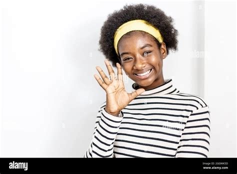 Cute African American Girl Wearing Casual Clothes Waving Saying Hello