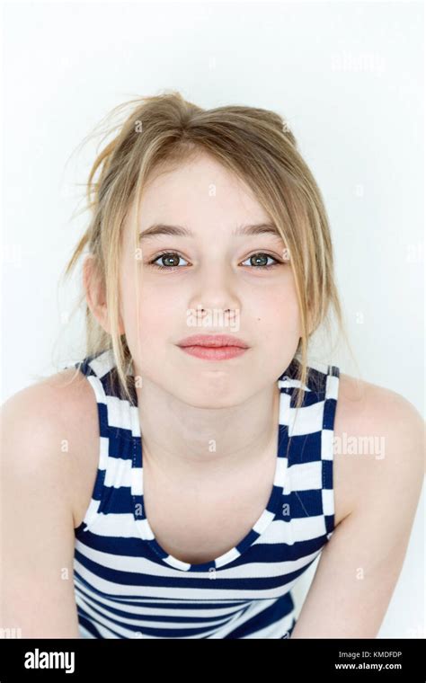 Close Portrait Of Girl Eleven Years Old With Big Green Eyes On White