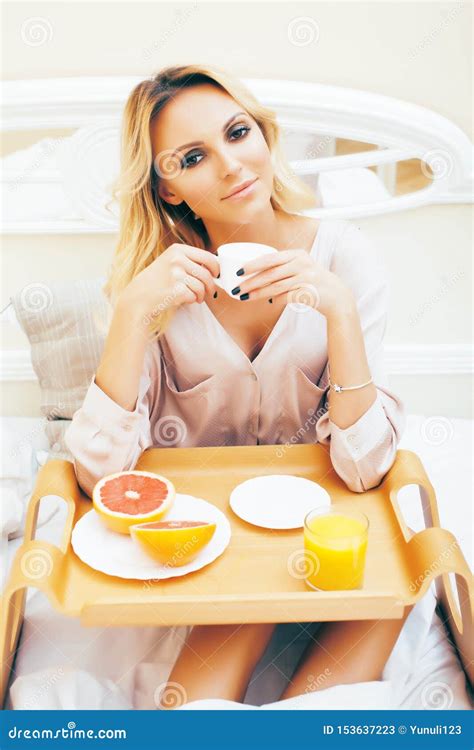 Young Beauty Blond Woman Having Breakfast In Bed Early Sunny Morning