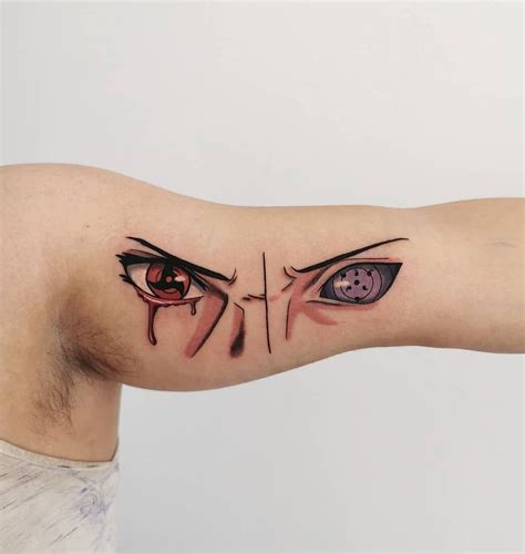 A Man S Arm With An Evil Face And Eyeball Tattoo On The Left Side Of His Arm