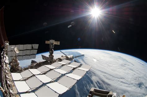 A Bright Sun A Portion Of The International Space Station And Earths
